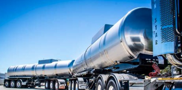 Long stainless steel tanker truck with a multi-tank trailer